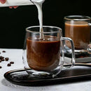Caneca de vidro borossilicato com parede dupla servindo café, ideal para bebidas quentes e frias com design elegante e isolamento térmico.
